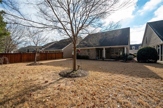 back of property featuring fence