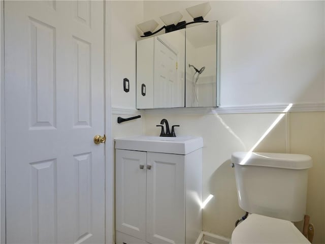 bathroom featuring toilet and vanity