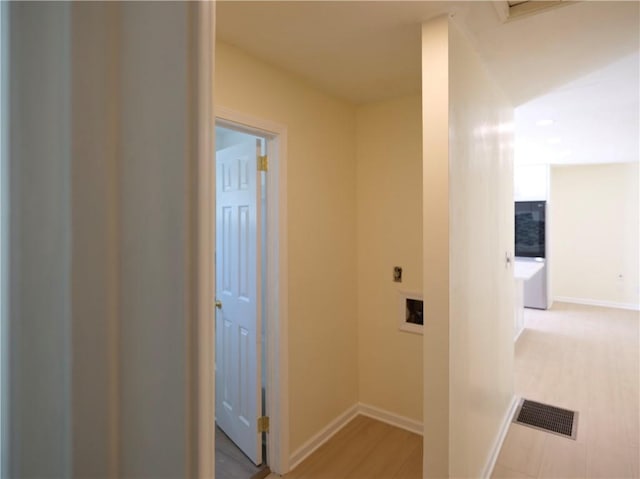hallway featuring baseboards and visible vents