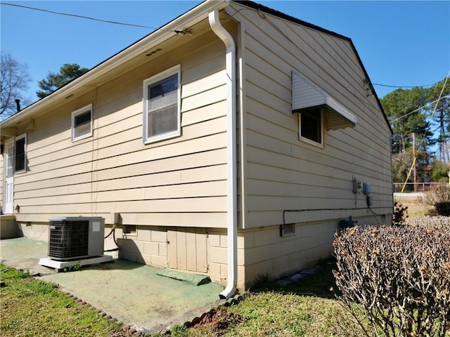 view of home's exterior with crawl space and cooling unit
