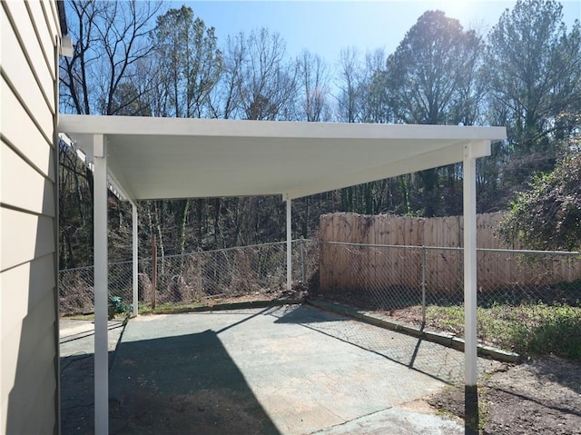 view of patio with a detached carport and fence