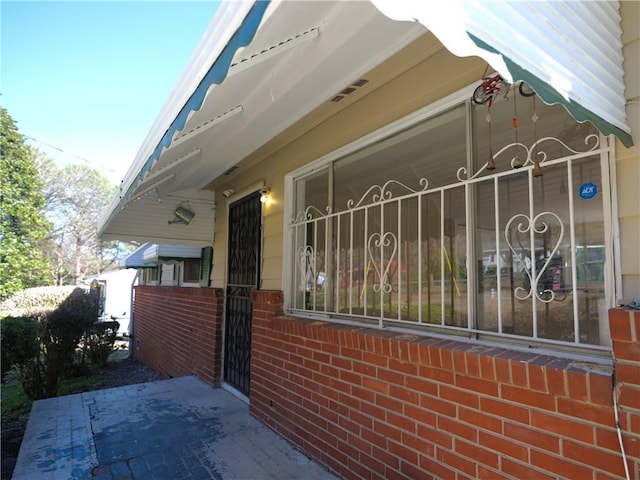 view of side of home with brick siding