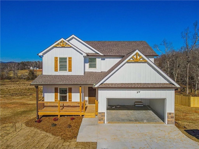 663 Wheeler Rd, Demorest, GA 30535 - view of front of home with board and batten siding, a porch, roof with shingles, an attached garage, and concrete driveway