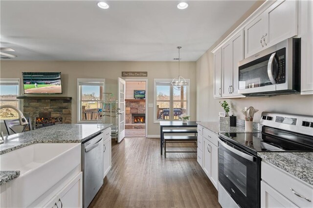 663 Wheeler Rd, Demorest, GA 30535 - kitchen with stainless steel appliances, a fireplace, a sink, and dark wood finished floors