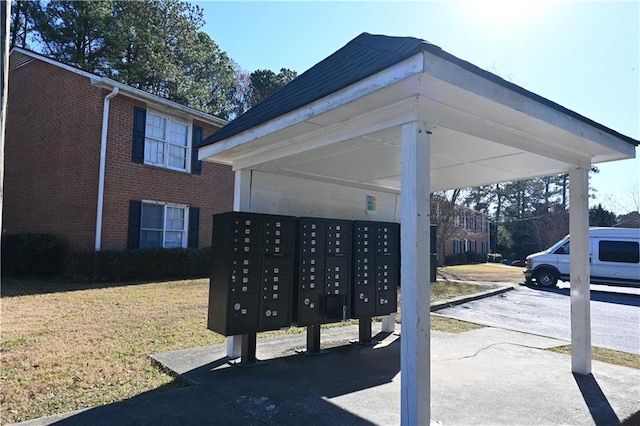 view of community featuring a yard and mail boxes