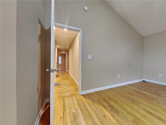 bonus room featuring vaulted ceiling and light wood-type flooring