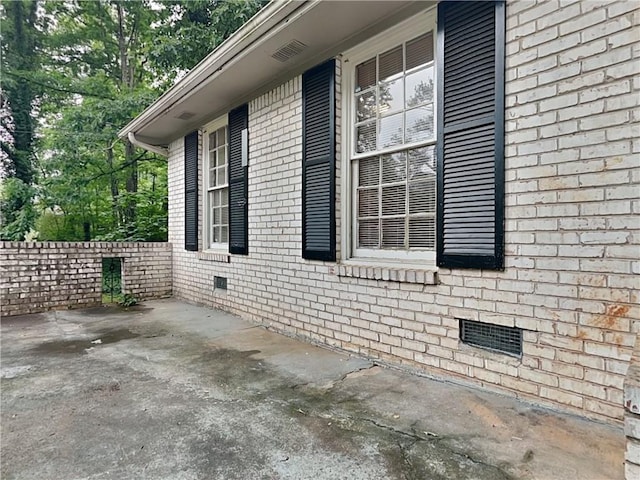 view of side of property with a patio area