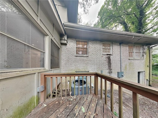 wooden deck featuring cooling unit