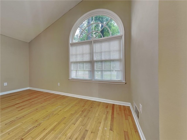 bonus room with vaulted ceiling and light wood-type flooring