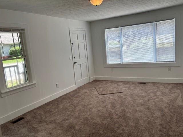 712 Emily St SE, Gainesville, GA 30501 - carpeted empty room with baseboards and a textured ceiling