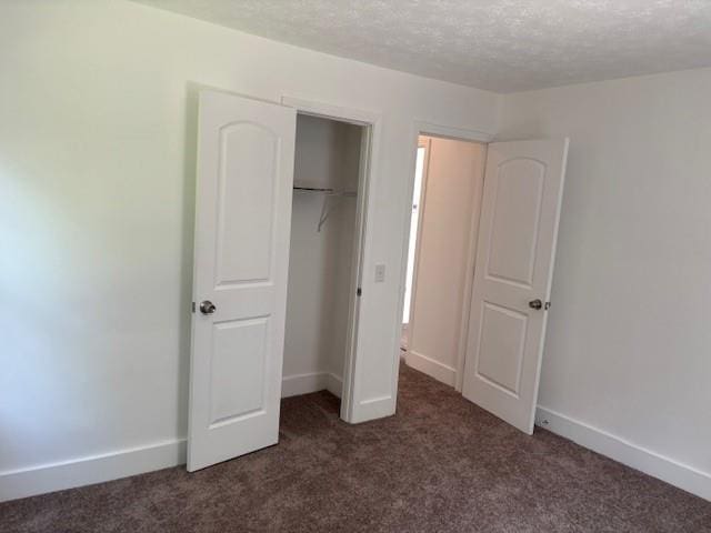 712 Emily St SE, Gainesville, GA 30501 - unfurnished bedroom with carpet floors, a textured ceiling, baseboards, and a closet