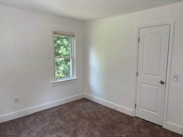 712 Emily St SE, Gainesville, GA 30501 - unfurnished room featuring dark carpet and baseboards