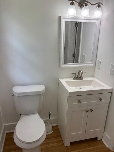 712 Emily St SE, Gainesville, GA 30501 - half bathroom featuring vanity, wood finished floors, and toilet