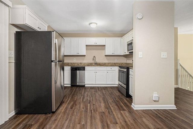 kitchen featuring white cabinetry, stainless steel appliances, dark wood-type flooring, and sink