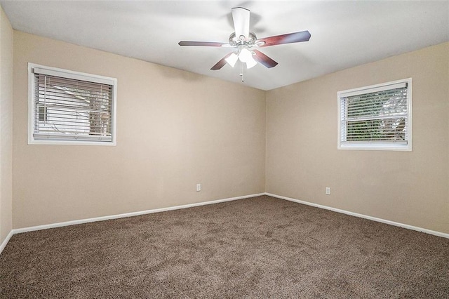 carpeted empty room featuring ceiling fan