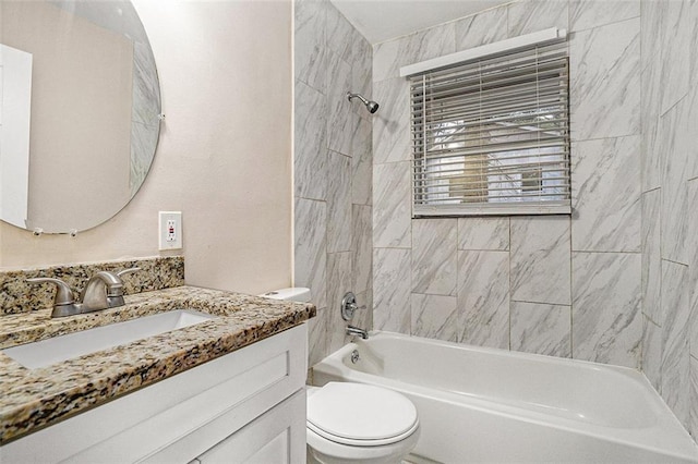 full bathroom with tiled shower / bath, vanity, and toilet