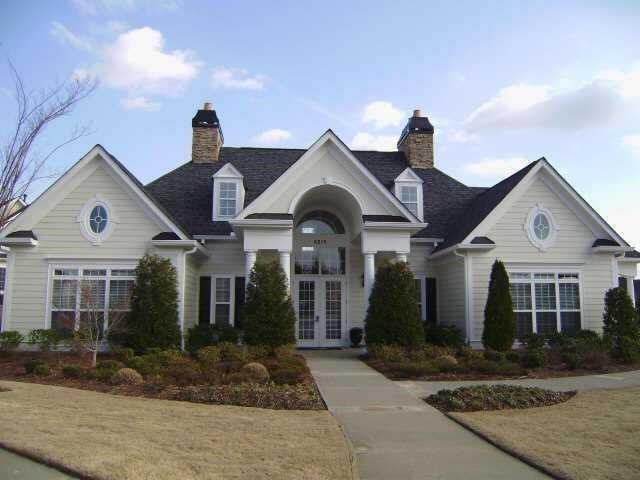 view of front of house with french doors and a front lawn