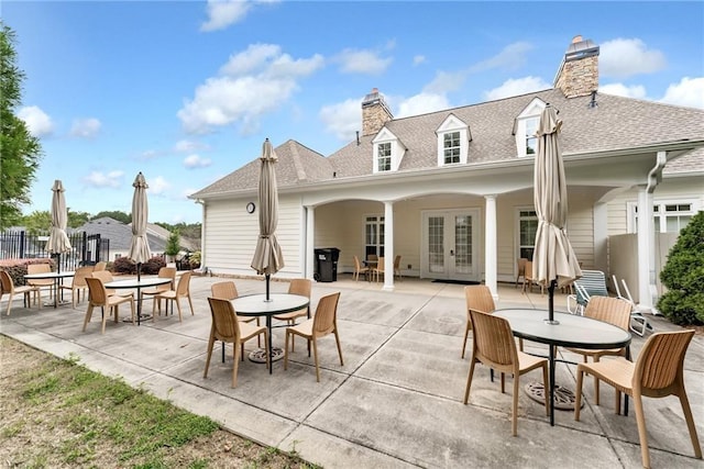 rear view of property featuring a patio and french doors