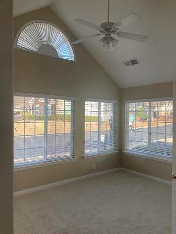 unfurnished sunroom featuring vaulted ceiling and ceiling fan