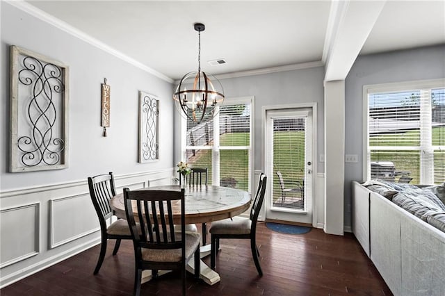dining space featuring a chandelier, dark wood finished floors, visible vents, and crown molding