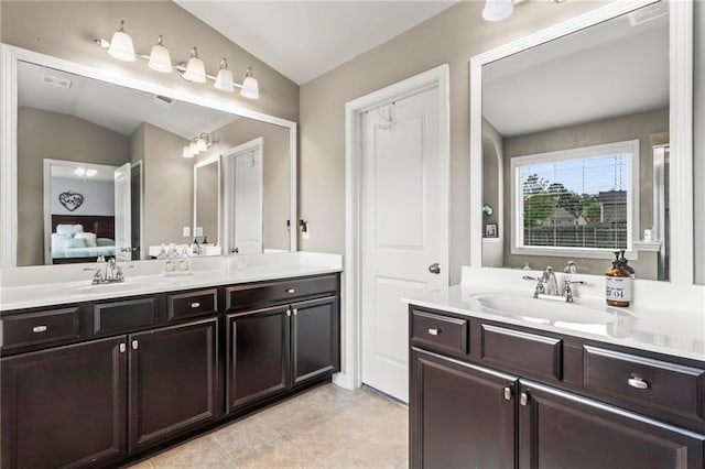 ensuite bathroom featuring tile patterned flooring, ensuite bath, and vanity