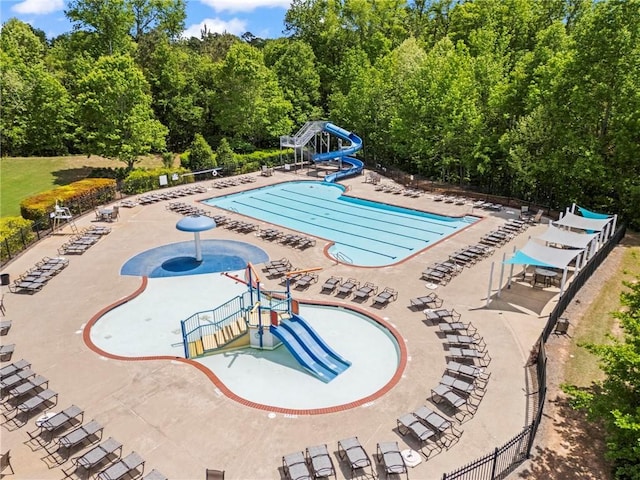 pool with a water slide and a water play area