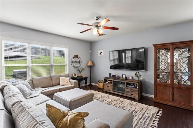 living area featuring dark wood finished floors, baseboards, a ceiling fan, and visible vents