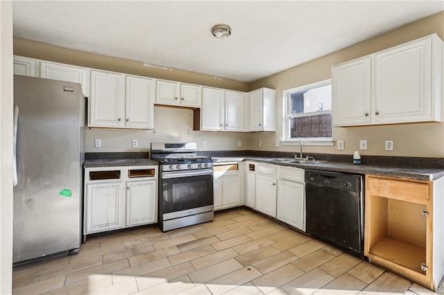 kitchen with appliances with stainless steel finishes, sink, and white cabinets