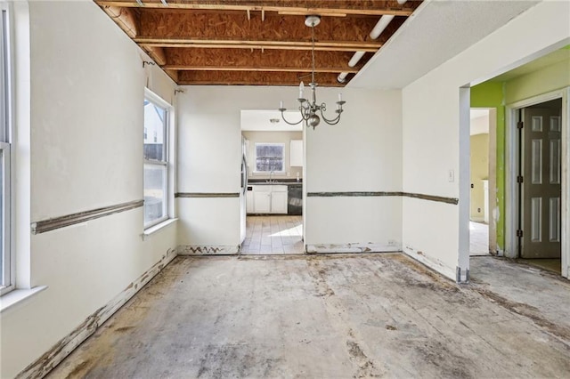 unfurnished dining area with a notable chandelier