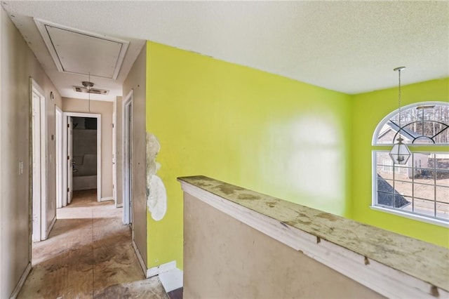 hallway with a textured ceiling