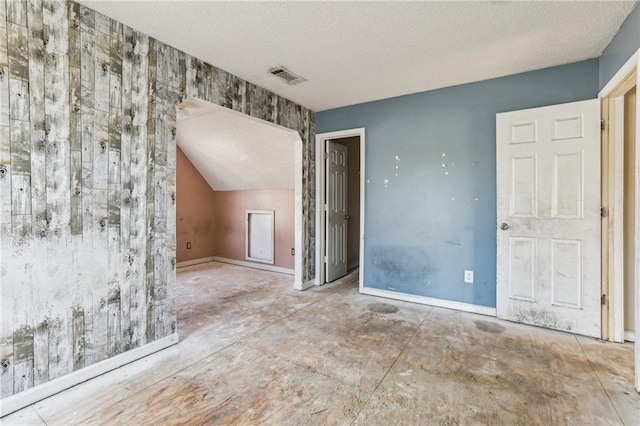 spare room with a textured ceiling