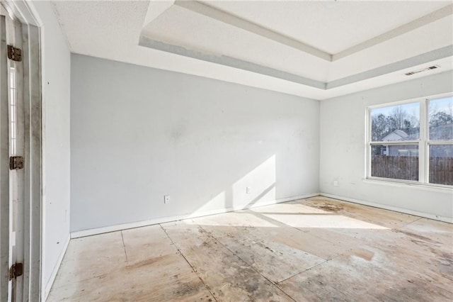 spare room featuring a tray ceiling