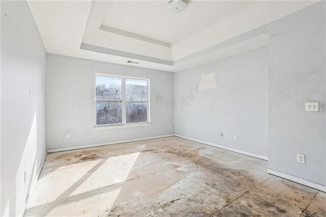 empty room featuring a tray ceiling