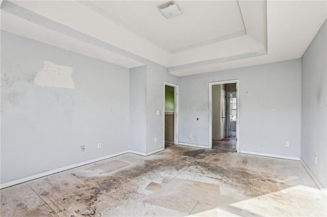 unfurnished room with a raised ceiling