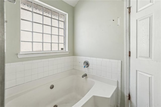 bathroom featuring a healthy amount of sunlight and a washtub