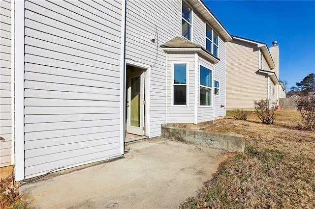 view of side of home with a patio area