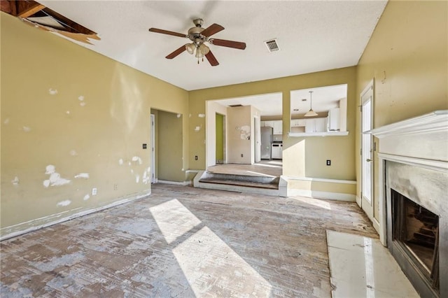 unfurnished living room with ceiling fan