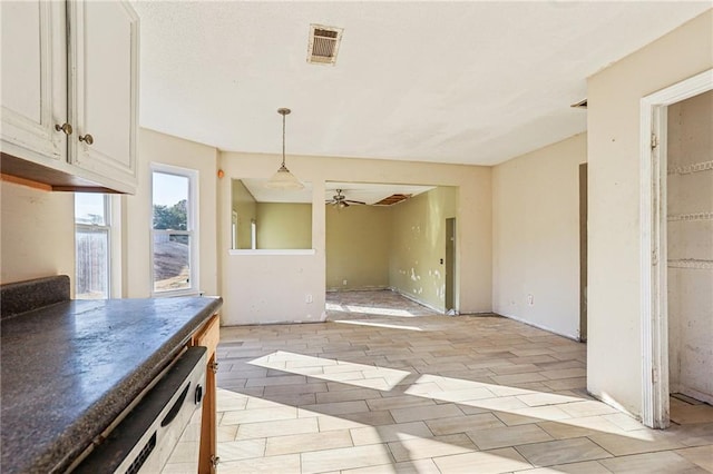 kitchen featuring white dishwasher, ceiling fan, decorative light fixtures, and white cabinets