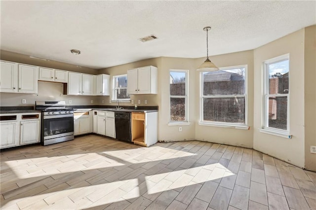 kitchen featuring sink, gas stove, decorative light fixtures, dishwasher, and white cabinets