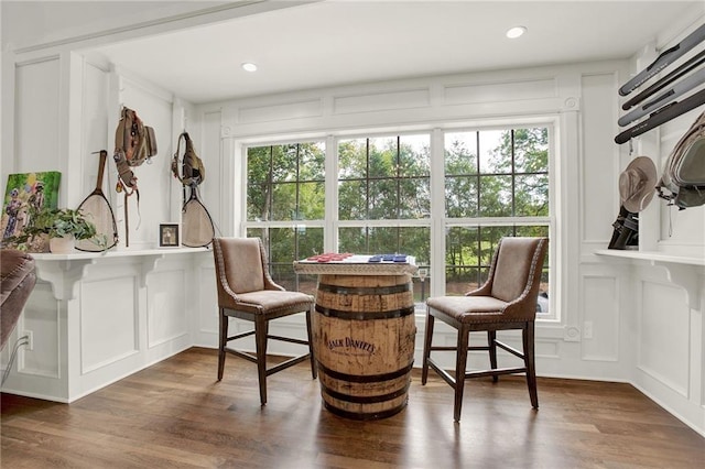 living area with plenty of natural light and dark hardwood / wood-style flooring