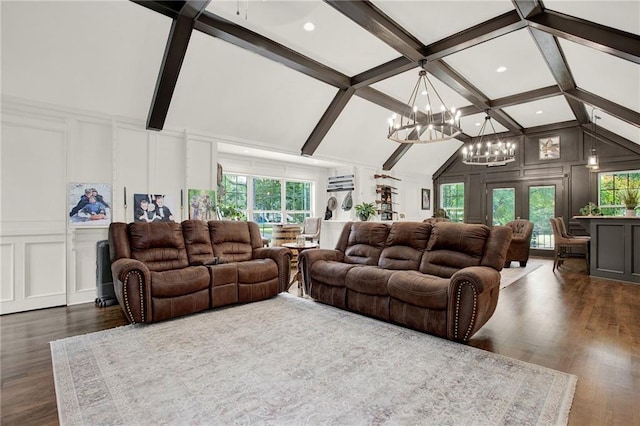 living room featuring a healthy amount of sunlight, lofted ceiling with beams, dark hardwood / wood-style flooring, and a notable chandelier