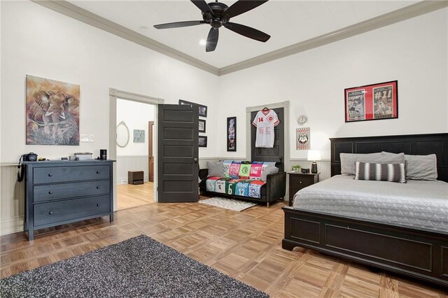 bedroom featuring ornamental molding, ceiling fan, and light parquet flooring