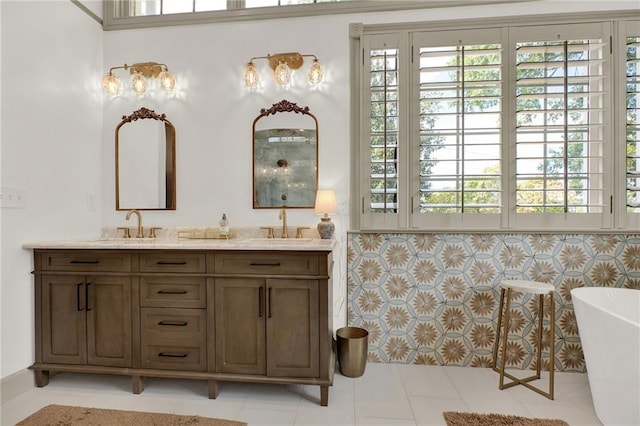 bathroom with vanity, a bathtub, and tile patterned floors