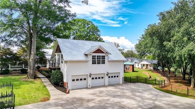 view of side of property featuring a garage and a lawn