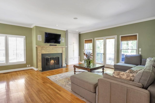 2190 Stephen Long Dr NE, Atlanta, GA 30305 - living room with crown molding, a fireplace with flush hearth, light wood-type flooring, and baseboards