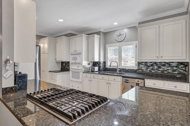 2190 Stephen Long Dr NE, Atlanta, GA 30305 - kitchen with a sink, stainless steel appliances, white cabinets, dark stone counters, and crown molding