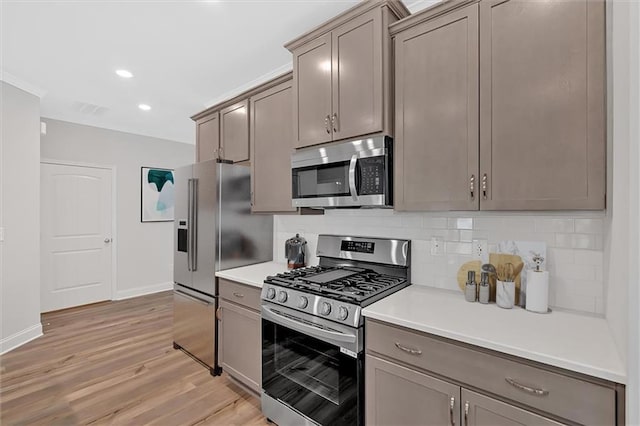 475 Azalea Xing, Dallas, GA 30132 - kitchen with baseboards, light countertops, light wood-type flooring, stainless steel appliances, and backsplash