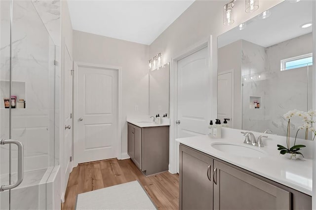 475 Azalea Xing, Dallas, GA 30132 - bathroom featuring two vanities, a sink, a marble finish shower, and wood finished floors