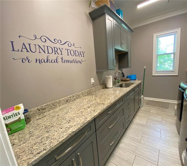 850 Cog Hl, Mcdonough, GA 30253 - clothes washing area featuring crown molding, washing machine and dryer, cabinet space, a sink, and baseboards