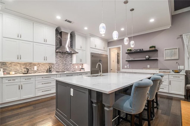 850 Cog Hl, Mcdonough, GA 30253 - kitchen featuring wall chimney range hood, crown molding, appliances with stainless steel finishes, a sink, and visible vents